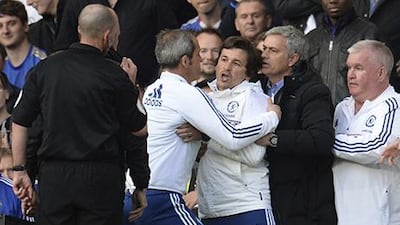 Chelsea’s manager Jose Mourinho, second from right, holds back assistant coach Rui Faria, centre, after he was sent off by referee Mike Dean, left, during their Premier League match against Sunderland at Stamford Bridge in London. Philip Brown / Reuters