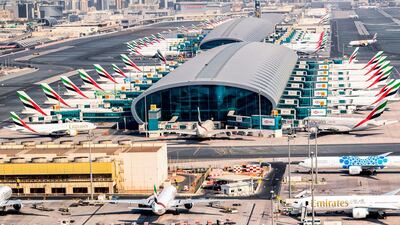 Parked Emirates planes on the tarmac at Dubai International Airport.