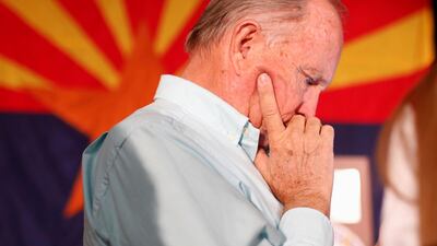 Supporter Mike Gipson checks results on his phone at the GOP watch party in Arizona. Reuters