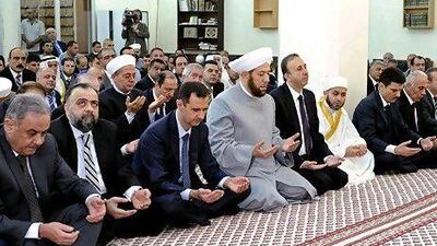 In this photo released by the Syrian official news agency SANA, Syrian president, Bashar Assad, performs Eid prayers in the Hamad Mosque in Damascus. It was his first public appearance since July 4.