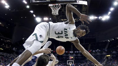 George Washington’s Jaren Sina passes the ball under pressure from UAB’s William Lee (34) during the second half of an NCAA college basketball game in Kansas City, Missouri. Charlie Riedel / AP