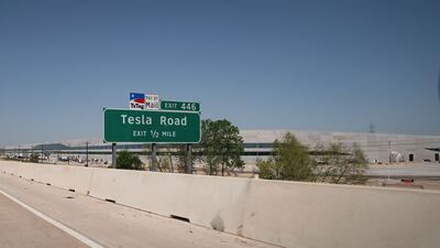 A Tesla Road exit sign on the Toll 130 motorway points to the new Gigafactory in Austin, Texas. AFP