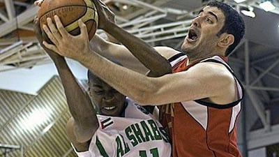 Rashed Naser of Al Shabab, left, and Mohammed Sale of Al Rayyan fight for a rebound.