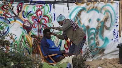 A migrant gets a shave at the Jungle migrant camp in Calais, France. Stephen Lock for The National