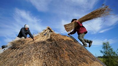 Volunteers recreate a Bronze Age roundhouse in Hampshire, southern England. PA