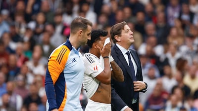 Real attacker Rodrygo leaves the pitch after picking up an injury in the first half. EPA