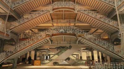 Wrought-iron balconies and banisters stand on the grand staircase in the atrium of the Samaritaine department store. Bloomberg