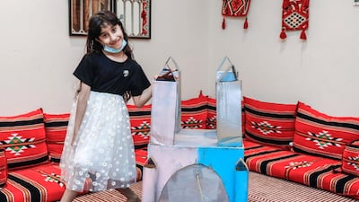 Eight-year-old Hind Alzaabi poses with the cardboard palace she built with the help of Adnoc's Stem@Home programme. Victor Besa /The National
