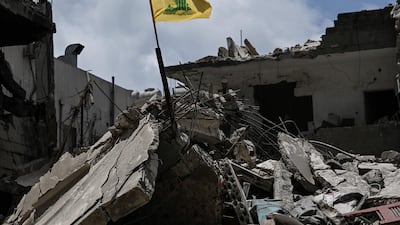 A Hezbollah flag on top of the rubble of a building in the southern Lebanese coastal city of Tyre on June 23. AFP