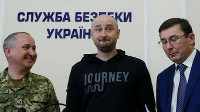 Russian journalist Arkady Babchenko, centre attends a news conference in Kiev that outlined the faking of his death. Valentyn Ogirenko / Reuters