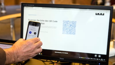 epa06330660 A mobile phone and a computer screen are seen during the demonstration of a blockchain-based digital ID in Zug, Switzerland, 15 November 2017. The city of Zug now offers all residents the opportunity to get a digital identity. This is based on an app and is linked to the Ethereum Blockchain. EPA/ALEXANDRA WEY