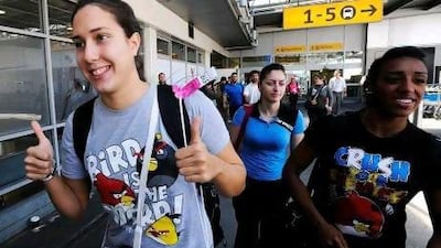 Members of the Syrian swimming team arrive at Heathrow airport, London, on July 23, 2012, four days ahead of the official opening of the London 2012 Olympic Games. AFP PHOTO *** Local Caption *** 046781-01-08.jpg