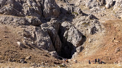 Turkish and Bulgarian rescuers stand at the entrance of Morca Cave as they take part in a rescue operation to reach U. S. caver Mark Dickey. Reuters