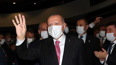 President Erdogan holds up his hand in the Rabia or Rabaa four finger sign of the Muslim Brotherhood. AFP