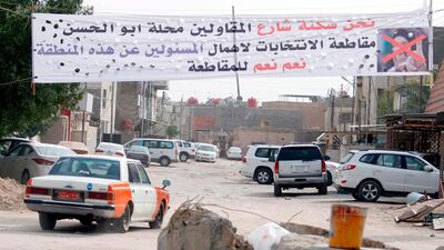 A banner calling voters to boycott the parliamentary elections in Iraq hangs in a neighbourhood in the southern city of Basra on May 8, 2018 as residents feel they are neglected by the federal government. Haider Mohammed Ali / AFP