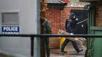 Police officers in black protective suits arrive with new equipment in the cordoned off area around The Mill public house, which had been visited by Sergei Skripal, in Salisbury, Britain, prior to his poisoning. REUTERS/Hannah McKay