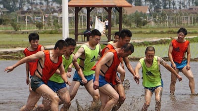 Chinese farmers playing football in a paddy field in Shenyang in China's northeastern Liaoning province. Despite Beijing's ambitions, the country is unlikely to become a major football power any time soon. AFP