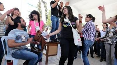 Participants at the World Social Forum dance to drum beats on the sidelines of the event in Tunis.