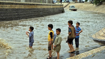 Children gather, undeterred by floods in the city. AFP