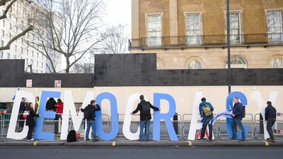 Demonstrators spell out the word "Democracy" as they protest in London. Reuters