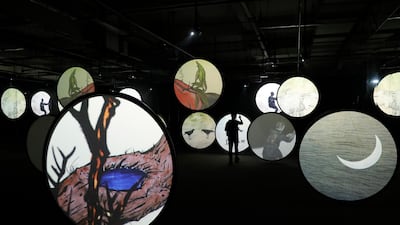 A visitor watches a work of digital art named 'Thousands of Moon' by Chinese artist Wu Junyong at the Asia Digital Art Exhibition in Beijing, China. EPA