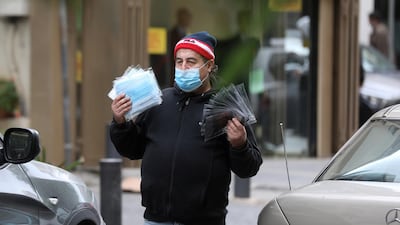 A street vendor sells face masks used to prevent the spread of the coronavirus disease (COVID-19), along a street in Beirut, Lebanon. REUTERS