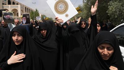 Iranian worshippers hold up the Quran in Tehran. The country's goverment condemned the desecration in Sweden. AP