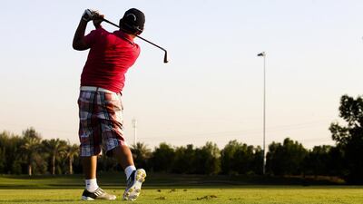 Saransh Raina follows through on a shot at the Abu Dhabi Golf Club during the Troon Junior Inter-Club Series, which was launched last month to entice aspiring athletes in the sport. Lee Hoagland / The National