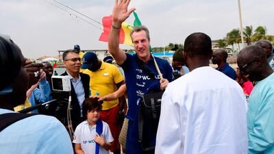 Patrick Bol, Dutch skipper of the Row4ocean rowing trimaran waves to the crowd before leaving Dakar. AFP