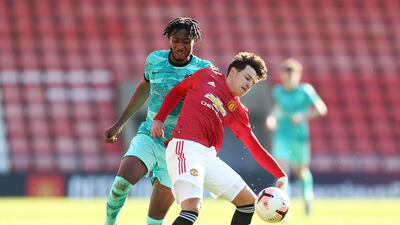 Manchester United's Marc Jurado battles for possession with James Balagizi of Liverpool. Getty Images