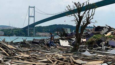A man walks through debris from the demolition of the Reina nightclub on May 22, 2017, near Bosphorus bridge in Istanbul. Yasin Akgul / AFP