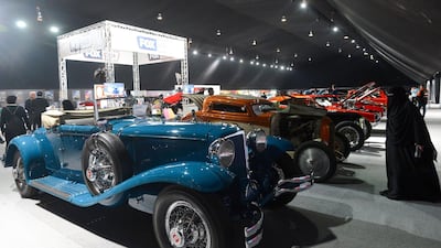 A Saudi woman looks at classic cars displayed for sale at a special exhibition in the Riyadh Motor Show, at Al-Janadriyah village in the Saudi capital. AFP