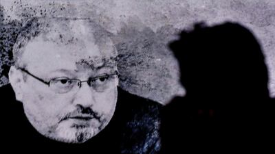 A man passes in front of a screen showing an image of Jamal Khashoggi during a commemoration event in Istanbul in November 2018. AFP