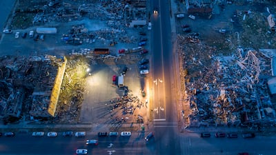 Members of Mayfield First Presbyterian Church and Mayfield First Christian Church gather in an empty lot between their destroyed churches for a joint Christmas Eve service in Mayfield, Kentucky. A tornado devastated the community about two weeks ago. AP