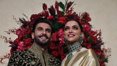 Padukone wore a gold sari by Angadi Galleria, while Singh chose an embroidered sherwani by Rohit Bal. Photo / AFP