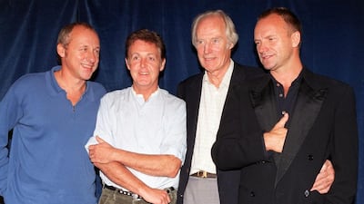 In this 1997 file photo, producer George Martin, second right, poses with musicians Mark Knopfler, Paul McCartney and Sting, prior to the start of the Music for Montserrat benefit concert, in London. Rebecca Naden / PA via AP