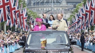 A pigeon flies ahead of Britain’s Queen Elizabeth and Prince Philip, and Princes William, Harry and Kate Duchess of Cambridge on The Mall in London. Toby Melville / Reuters