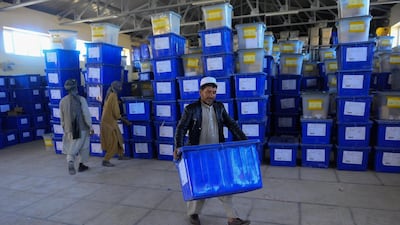 Afghan employees of the Independent Election Commission (IEC) carry ballot boxes at a warehouse in Herat province on October 17, 2018. AFP