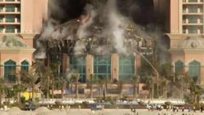 A fire burns in the five-star Atlantis hotel, which is still set to open this month.