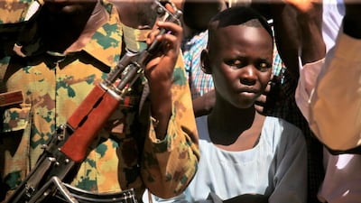 A child looks on as Sudan's prime minister visits a camp for internally displaced people (IDP) in El-Fasher, the capital of the North Darfur state. AFP