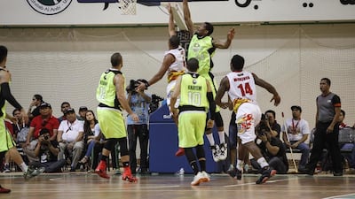 Jarrid Famous of GlobalPort Batang Pier goes for a rebound against Rain or Shine Elasto Painters' Paul Lee during their PBA game on Thursday in Dubai. Antonie Robertson / The National