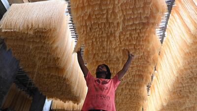 A worker in Lahore, Pakistan, dries vermicelli used to make a traditional sweet dish popular during Ramadan. EPA