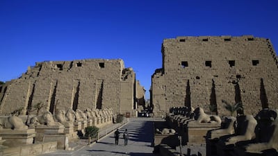 Tourist look out at the ruins of the Karnak Temple in Luxor. Foreign tourism, a major part of Egypt's economy, has been hurt by the unrest and political upheaval. Hassan Ammar / AP Photo