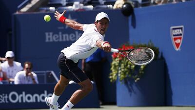 Novak Djokovic of Serbia reaches for a return to Kei Nishikori of Japan during their semi-final at the US Open in New York on September 6, 2014. Mike Segar / Reuters
