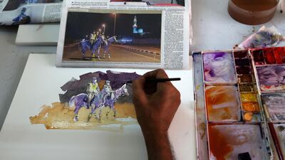 Artist Atul Panase paints a picture from 'The National' newspaper. Pawan Singh / The National