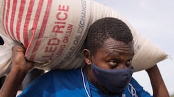 A World Food Programme staff member loads food on a UN helicopter in Haiti, August 19, 2021. Last year, the WFP revealed that it was facing a staggering 40 per cent reduction in funding. EPA