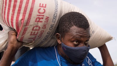 A World Food Programme staff member loads food on a UN helicopter in Haiti, August 19, 2021. Last year, the WFP revealed that it was facing a staggering 40 per cent reduction in funding. EPA