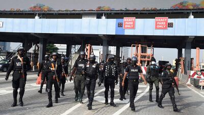 Police officers arrive at the scene of the rally to commemorate the one-year anniversary of the October 20, 2020 protest, when security forces shot at people gathered at the Lekki toll gate. AFP