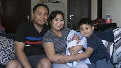 Nicholas Dean Sacramento, the premature baby who weighed only 530grams at birth, with his mother, Susie May, father Christopher Sacramento, and brother Amiel Dane Sacramento, 8 years old. Mona Al Marzooqi / The National
