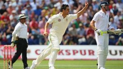 Mitchell Johnson of Australia celebrates the wicket of Ravi Bopara as Kevin Pietersen looks on during the opening day's play in the first Ashes Test at the SWALEC Stadium in Cardiff, Wales.